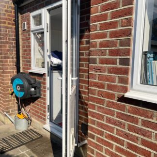 Two angled doorstops stopping door hitting brickwork